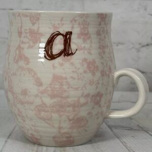 Anthropologie HOMEGROWN monogram A mug on blush pink floral pattern.
